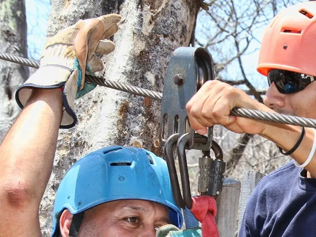 A guest prepares at a zipline platform.