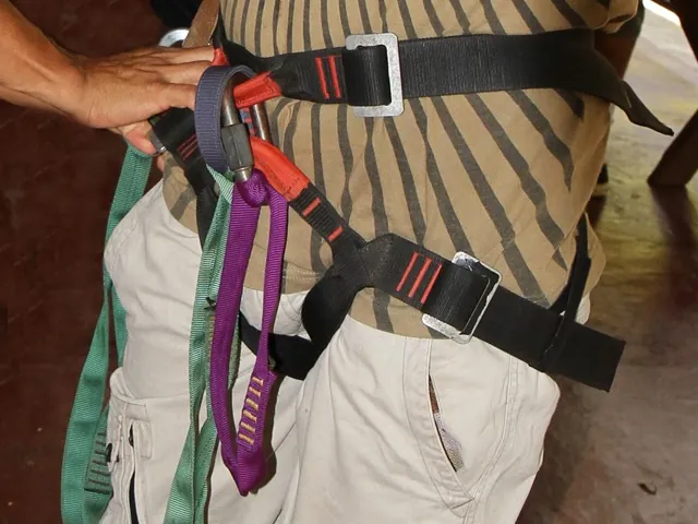 Close view of a zipline guest’s safety harness and straps.
